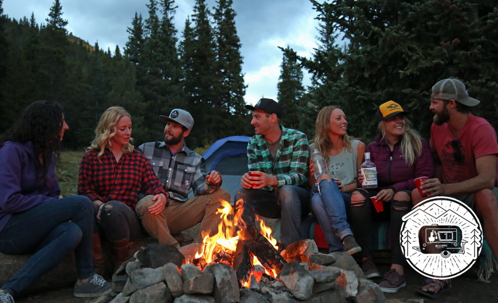 friends drinking around bonfire