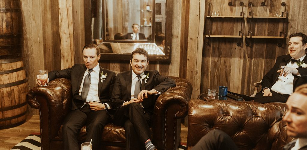 men in suits with cocktails