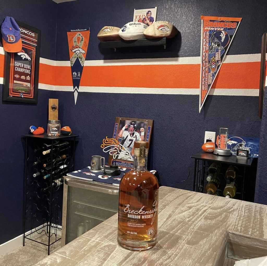 @kimj2008 Denver Broncos-themed room with bottle of Breckenridge Bourbon Whiskey on counter